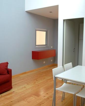 Dining area with hardwood flooring throughout the apartment